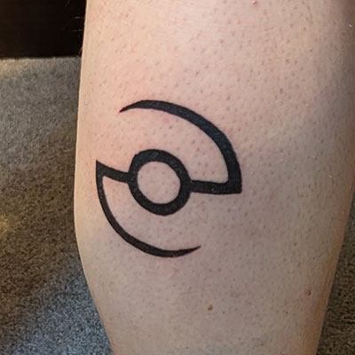 Pokeball outline tattooed on the back of a leg